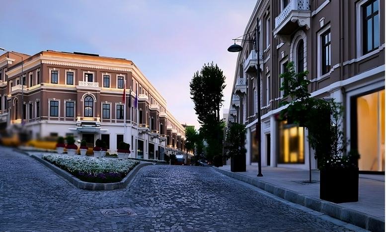 Exterior street view of the historic stone-paved Akaretler Rowhouses at dusk.