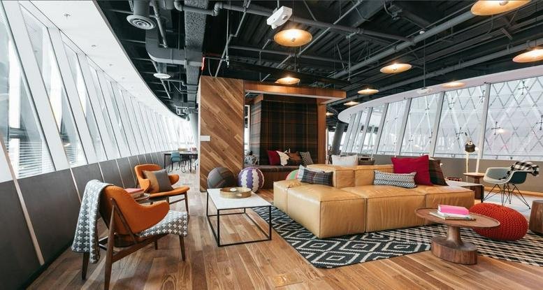 Spacious communal lounge at Sinarmas MSIG Tower with leather sofas and large windows.