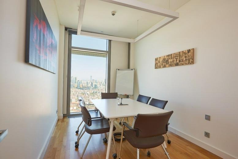 Meeting room with a white table and city views at Emaar Square, 29th Floor, Libadiye Cad.