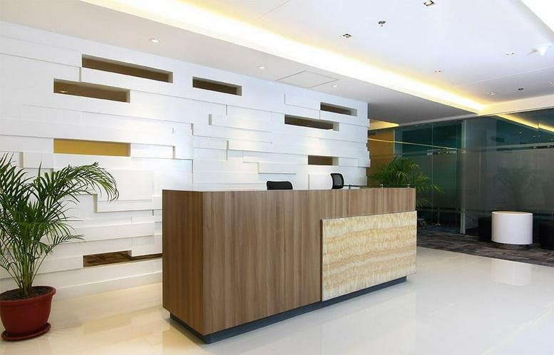 Wood-paneled reception desk in the lobby of SM Aura Office Tower.