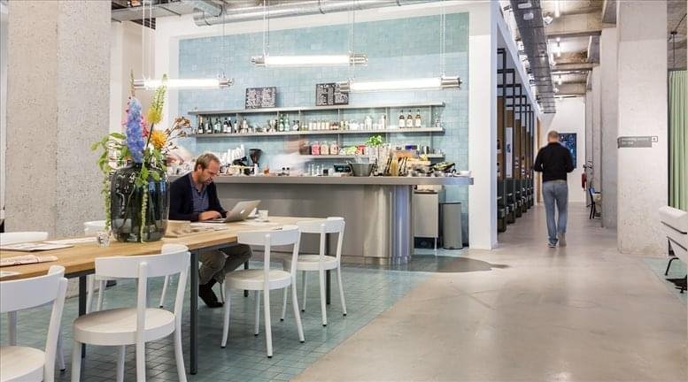 Open-plan workspace with dining area and kitchen.