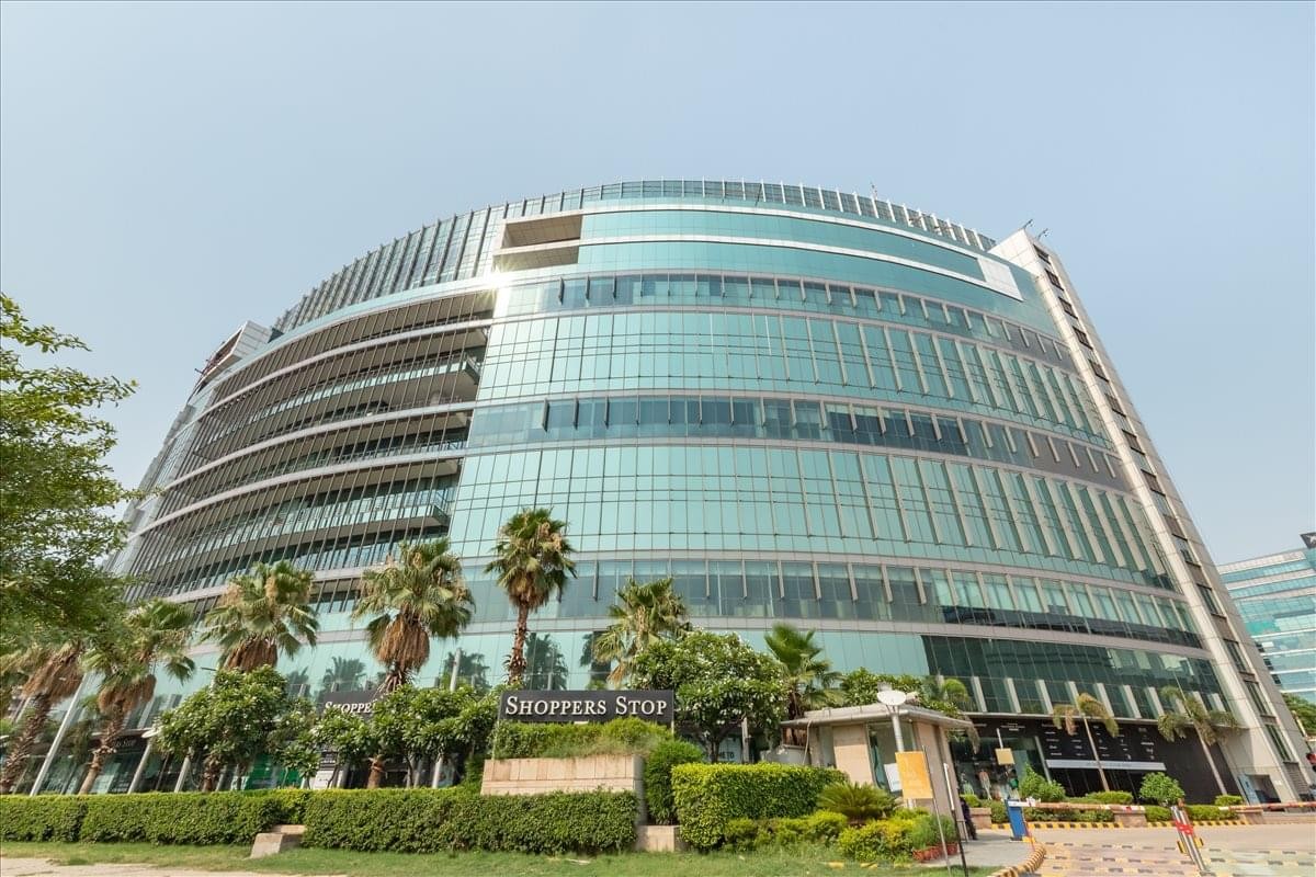 Exterior view of the curved glass facade of the Spaze I-Tech Park building.