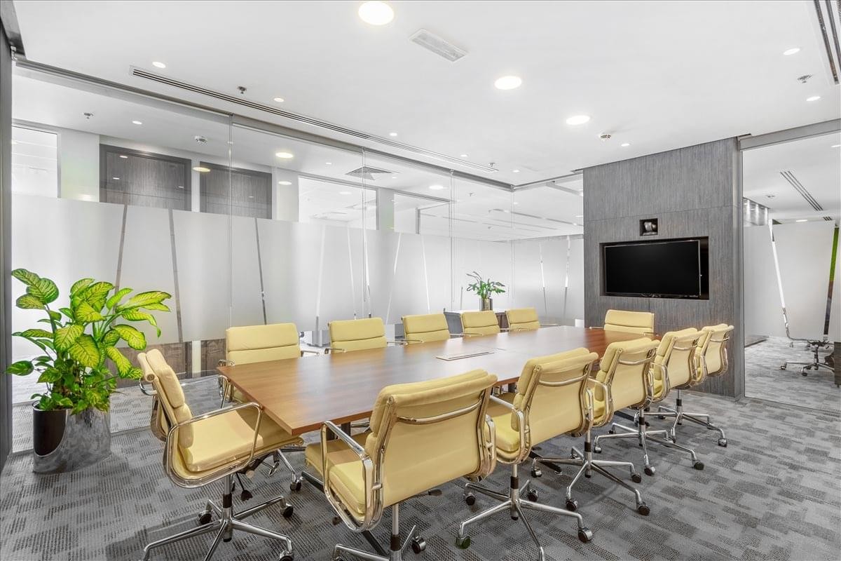 Professional boardroom at Standard Chartered Tower, Emaar Square with seating for twelve.