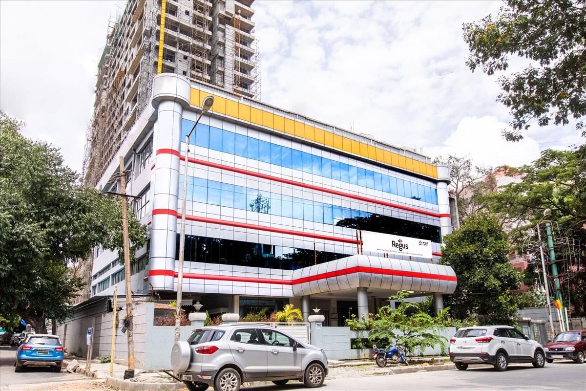 Exterior view of the glass and metal Supreme Overseas Exports Building with its distinctive red and white accents.