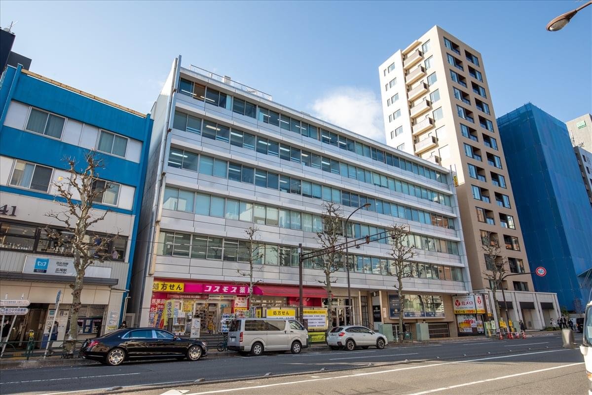 Street-level view of the Taisei Koki Building featuring a modern facade and retail ground floor.