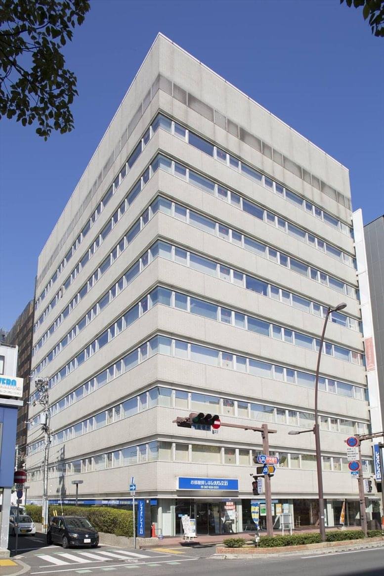 Exterior view of the light grey Takamatsu Kotobukicho Prime building against a clear blue sky.
