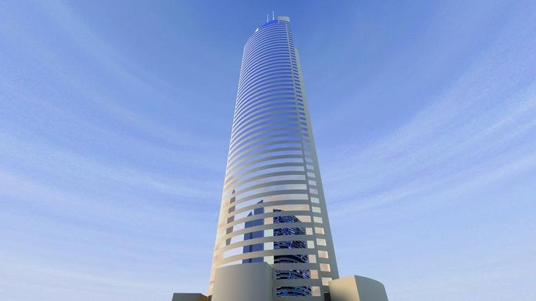 Exterior view of the soaring glass facade of Tamkeen Tower against a blue sky.
