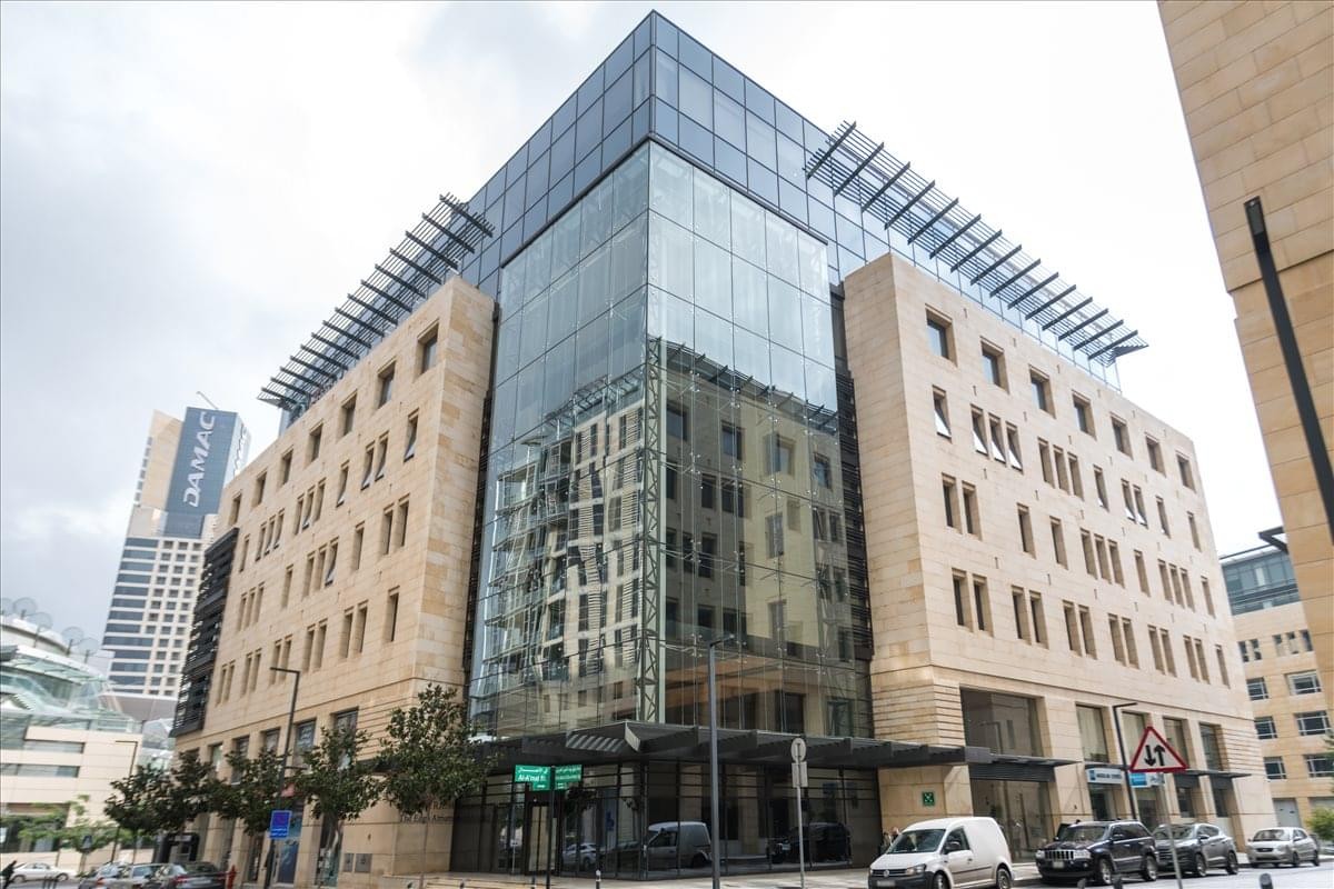 Exterior view of the glass and stone facade of The Edgo Atrium.