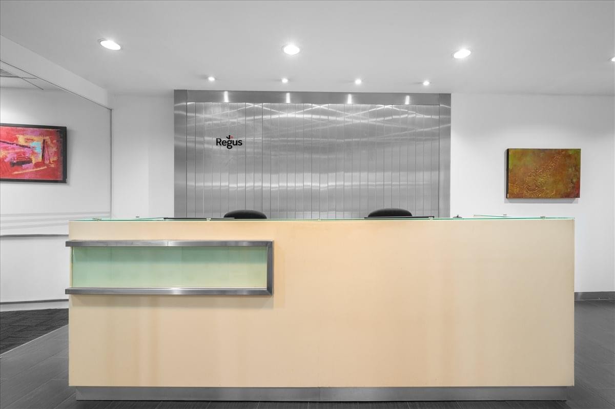 The Gardens South Tower, Level 28, Mid Valley City reception desk with a brushed metal backdrop.