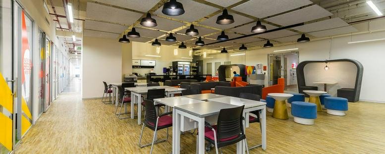 Open-plan coworking space with multiple seating options.