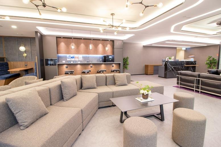 Spacious lounge area with modern seating and soft lighting.
