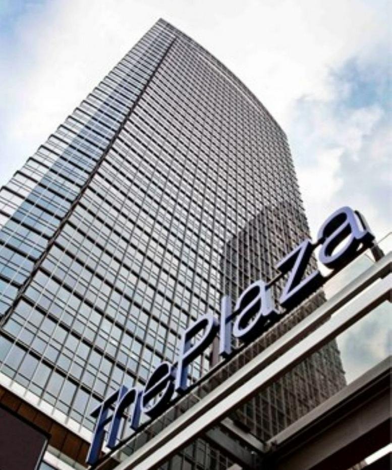 Low-angle exterior view of the glass skyscraper at The Plaza Office Tower.