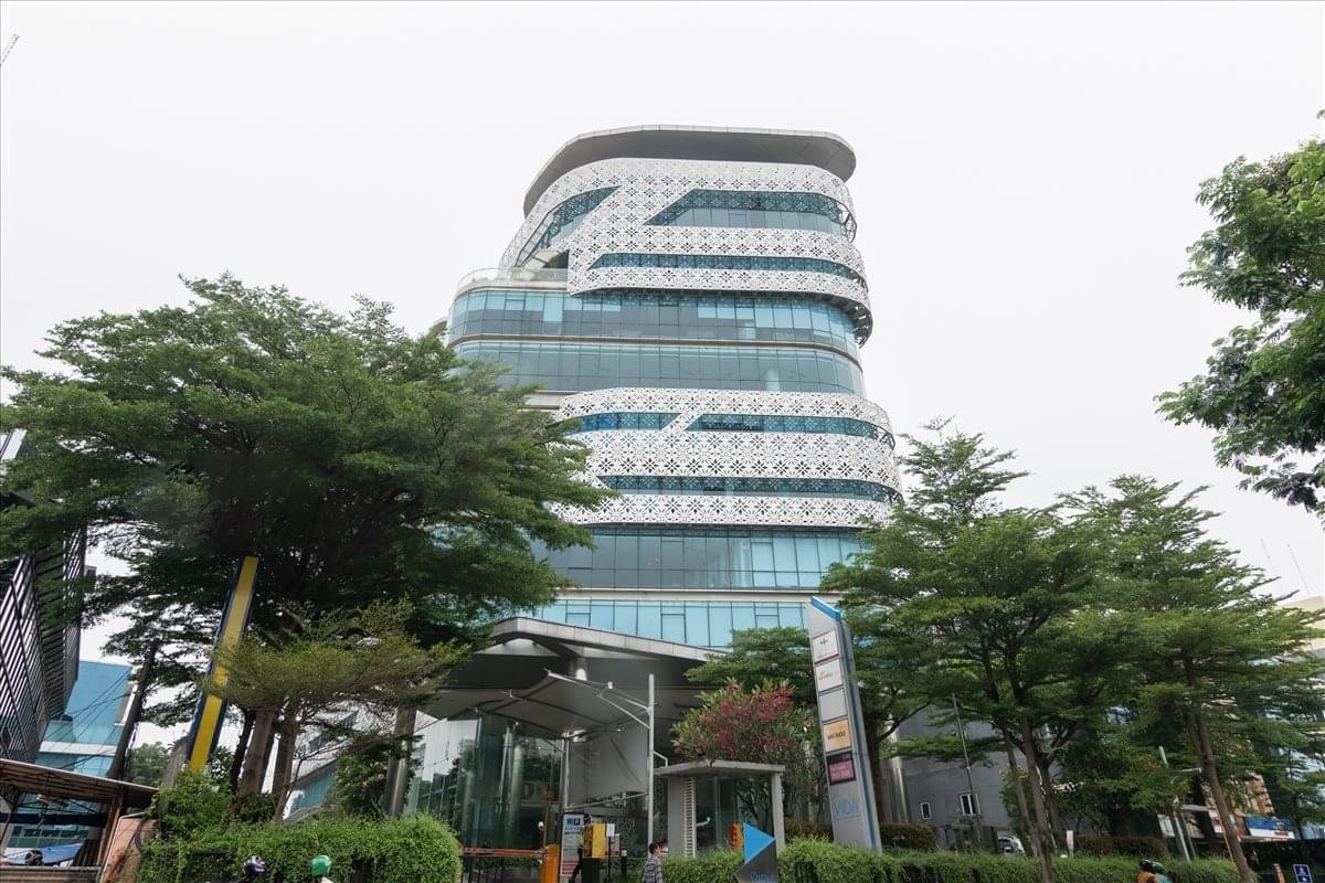 Exterior view of the modern, glass-paneled facade of The Vida building.