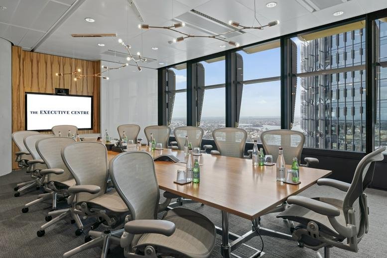 Boardroom at Three International Towers Sydney with a large wooden table and city views.