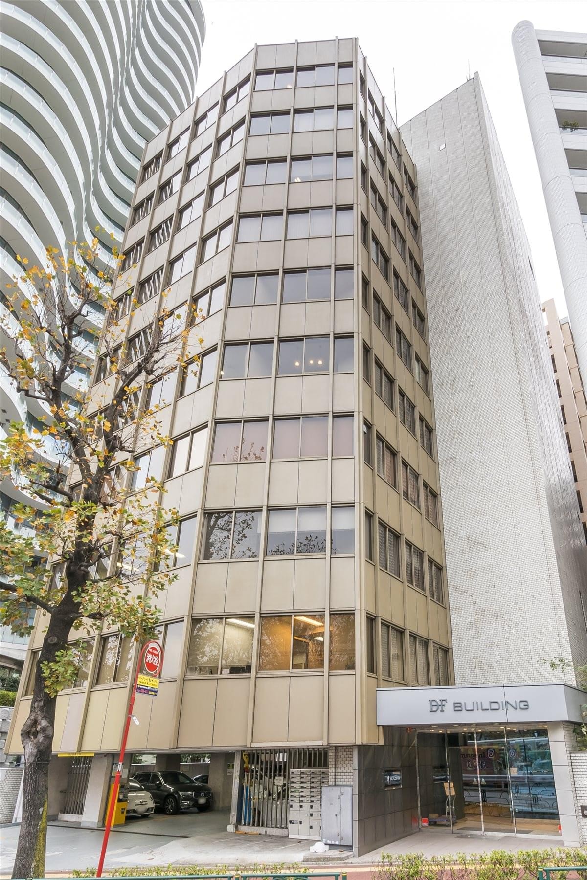 Exterior view of the DF Building showing its glass and metal facade from street level.