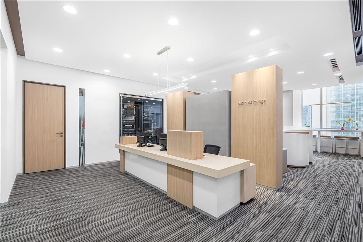 Sleek reception desk in International Finance Square (IFS) with wood-paneled feature walls.