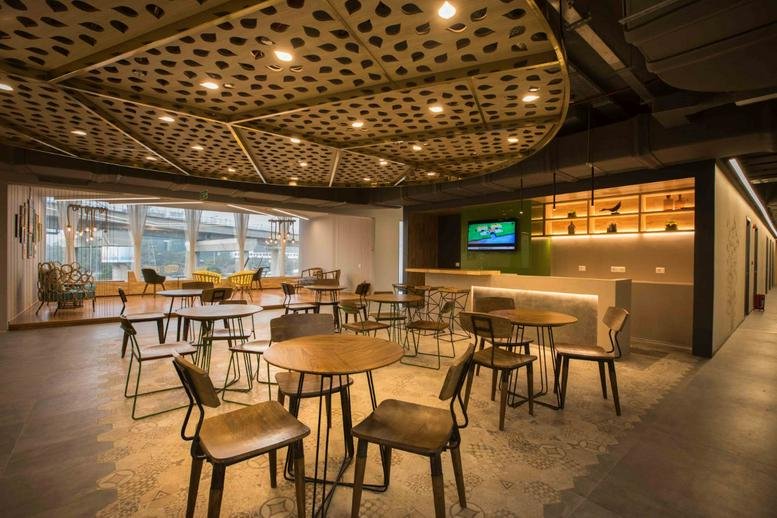 Spacious communal lounge at Tower A, Building 10, Level 1, Cyber Hub, Gurugram, India with a designer lattice ceiling.
