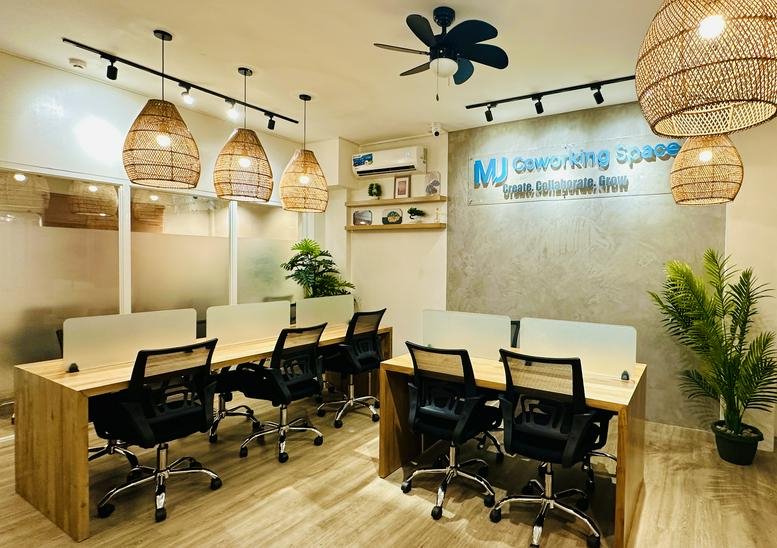 Spacious interior of the coworking space at KBM Building, 2nd Floor with wicker lamps and wooden desks.