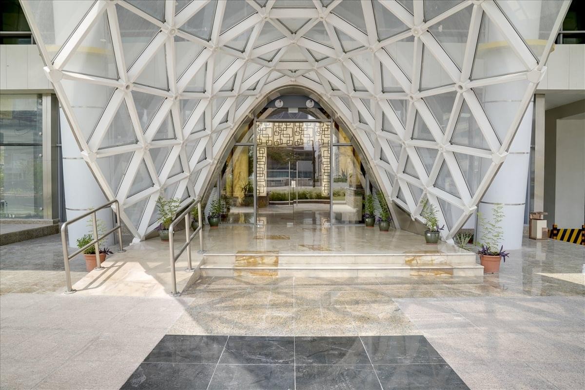 The geometric white vaulted glass entrance at the Twin Towers, Lusail, Doha.