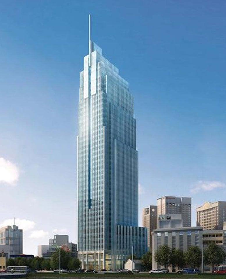 Exterior view of the glass-facade Vietcombank Tower skyscraper against a blue sky.