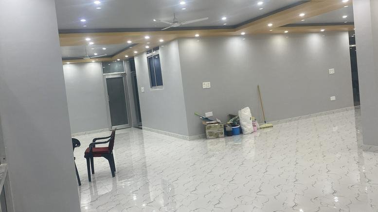 Spacious open-plan interior at Vishal Commercial Complex with polished tile floors and recessed lighting.
