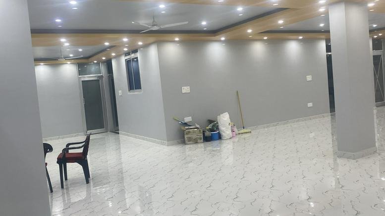 Bright interior view of the Vishal Commercial Complex featuring polished floors and recessed lighting.