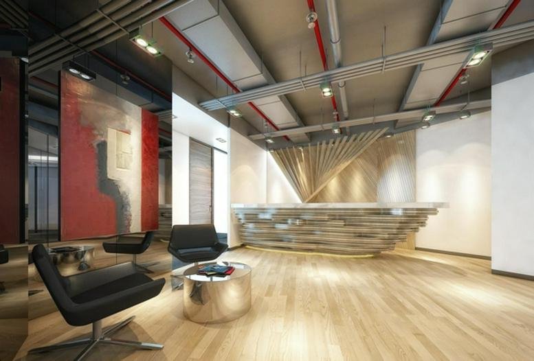 Spacious reception area of Westgate Tower featuring a sculptural wooden desk and industrial ceiling.