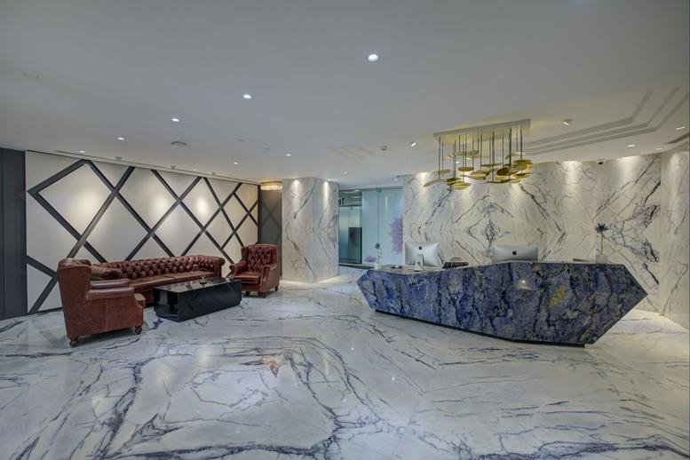 Lobby at World Trade Center, Level 9, Tower 2, Kharadi with a blue stone reception desk and marble floors.
