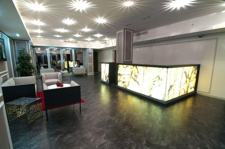 Spacious reception area at Yapi Kredi Plaza featuring a glowing front desk and starry ceiling lights.