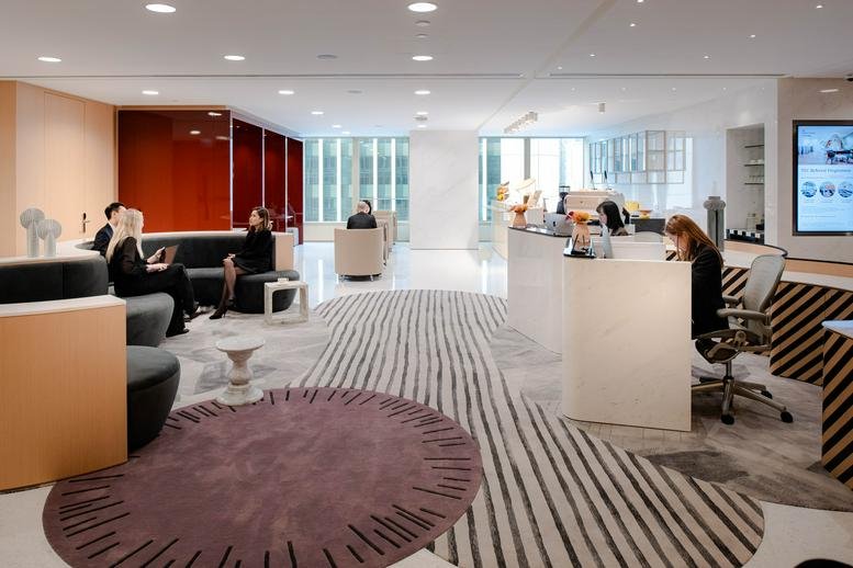 Spacious reception and lounge at Level 20, One IFC with curved patterned carpets and modern seating.