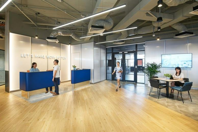 Reception and lobby area with blue desks at One North Crescent, Level 7, Singapore.