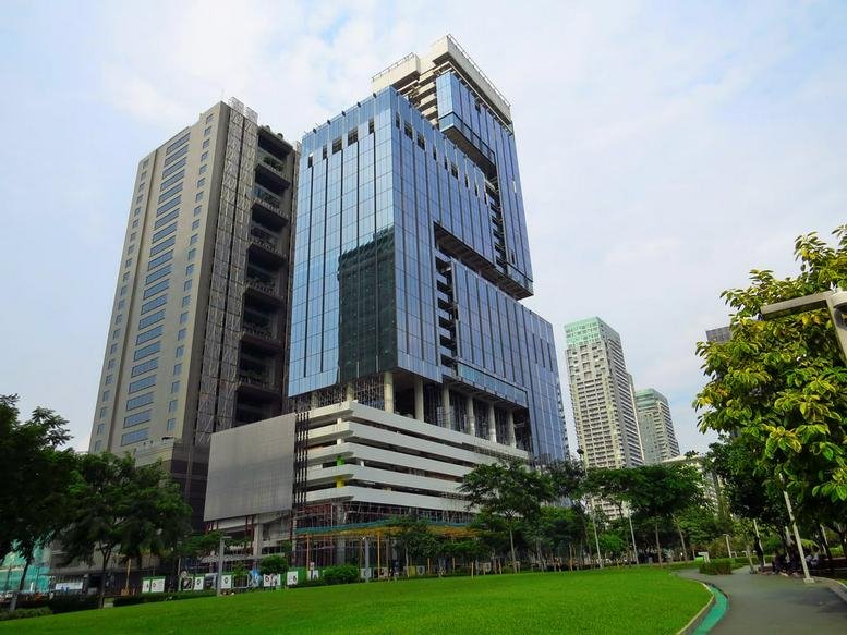 Exterior view of the modern glass and steel ORE Central building in Bonifacio Global City.