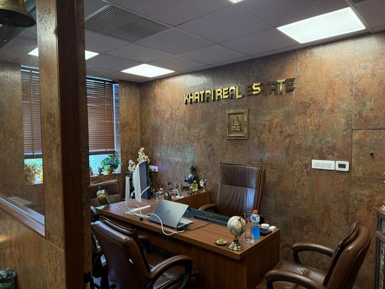 Professional private office at Parasvnath Plaza, Sector-27 2nd Floor Unit-1, with a wooden desk and leather chairs.
