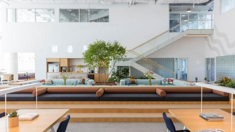 Spacious, modern communal lounge at Parkview Place, 2 East 4th Ring Road, Beijing with a central tree and tiered seating.