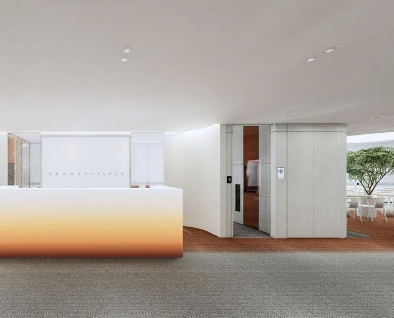 Sleek, modern reception area at Mid Valley Southkey North Tower with warm gradient desk and wooden accents.