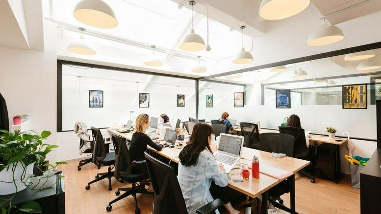 Open-plan office space at Platinum Tower, 1 Tairan 7th Road with rows of desks and glass-walled meeting rooms.