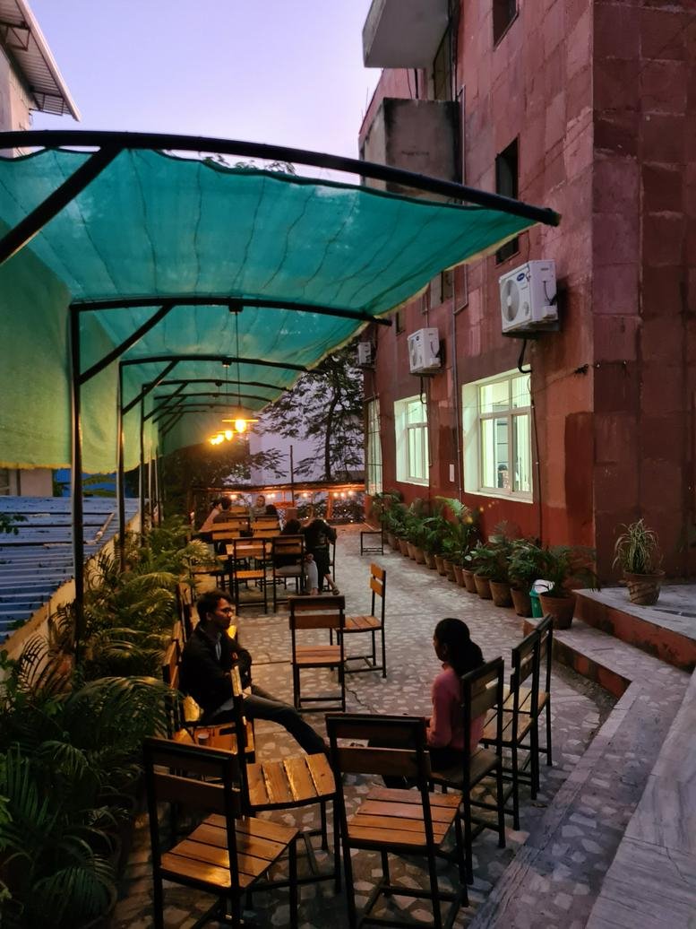 Exterior courtyard at Plot no. 8, Govind Marg, Block-B, Malviya Nagar with covered outdoor seating.