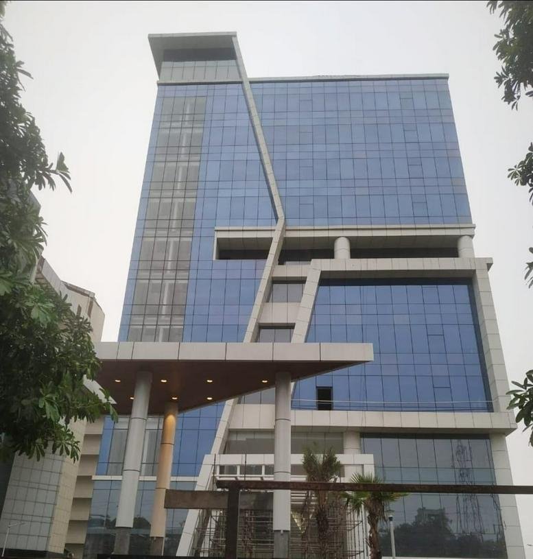 Exterior view of the modern glass-facade building at K R Signature, Plot No. 3, Sector 135.