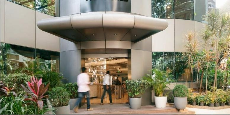Exterior entrance of Prestige Atlanta 80 Feet Main Road, Koramangala, Bengaluru with a curved modern canopy.