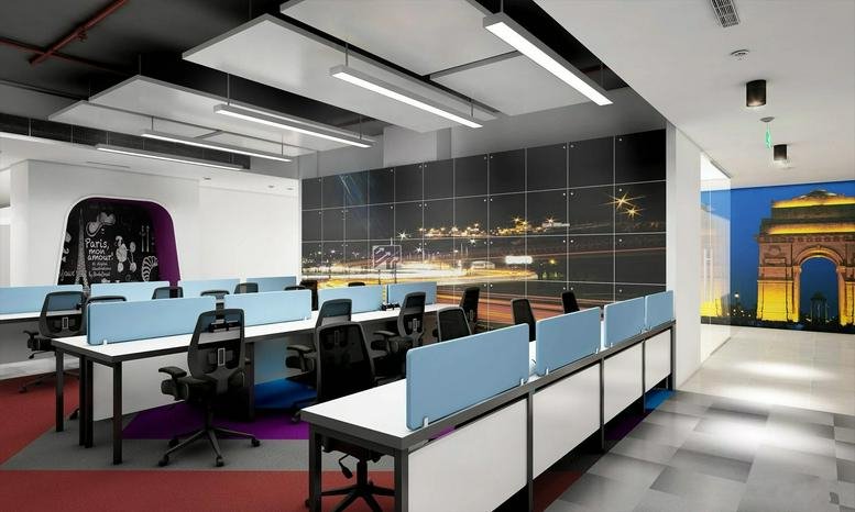 Spacious open-plan workspace at Pride House featuring desks with blue dividers and a city skyline mural.