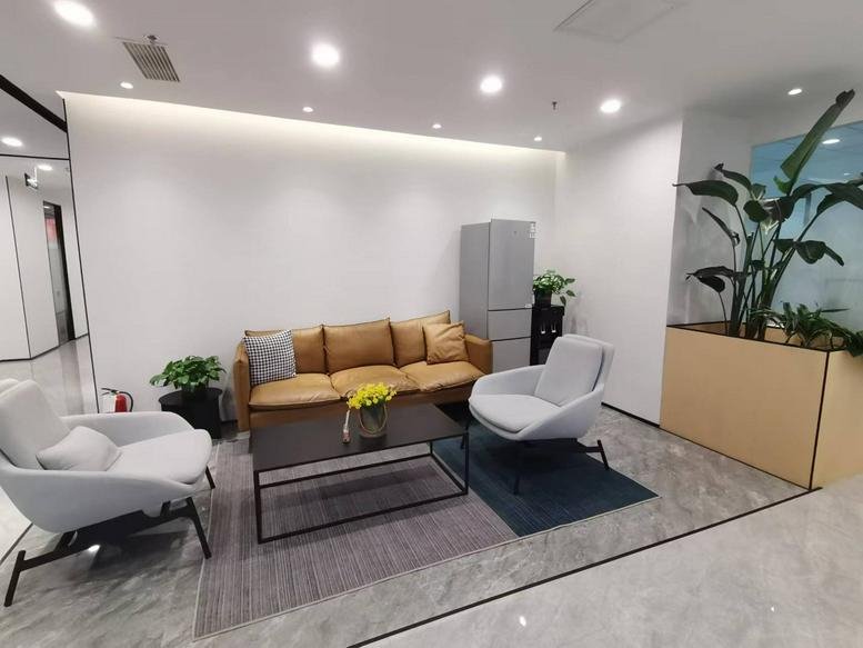 Lobby at the Publishing Building, No. 182 Haier Road, featuring tan leather sofas and grey accent chairs.