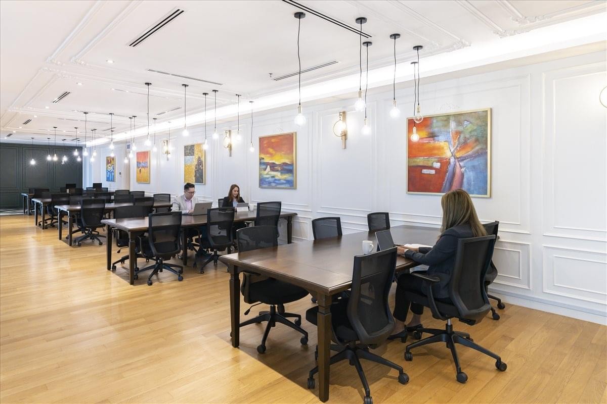 Spacious open-plan workspace at Q Sentral with natural light and multiple workstations.