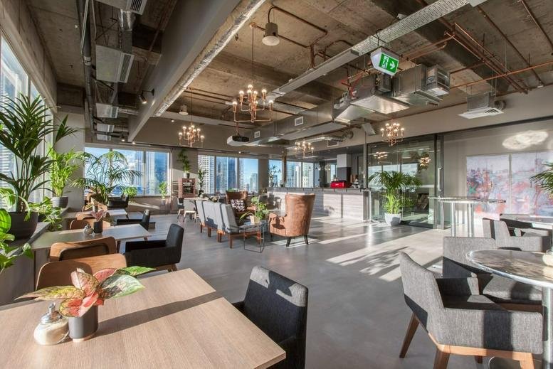 Spacious communal lounge at Queen Street, Level 17, 20, 21, 31 with industrial ceilings and city views.