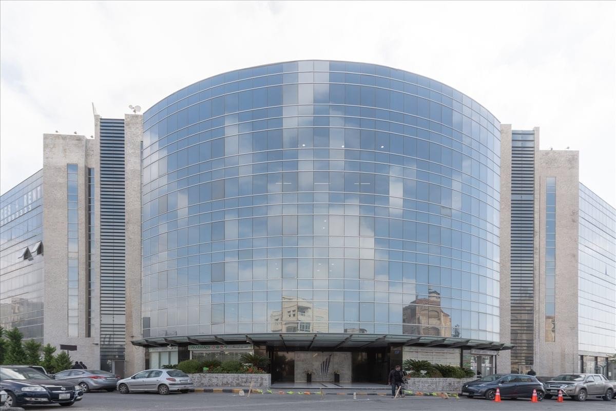 Exterior view of the glass-facade building at Queen Zain Al Sharaf Road, 5th Floor, Amman.