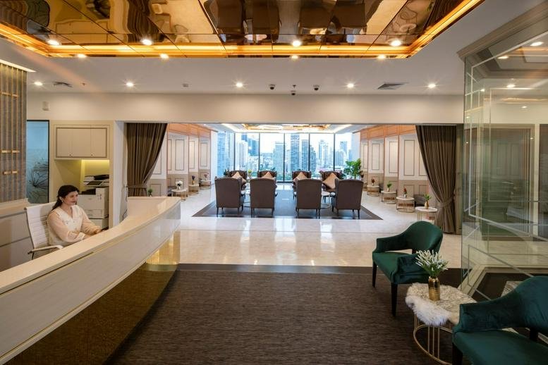 Elegant reception area of Rasa 2, Level 18, 1532 Phetchaburi Road with gold ceiling accents and city views.