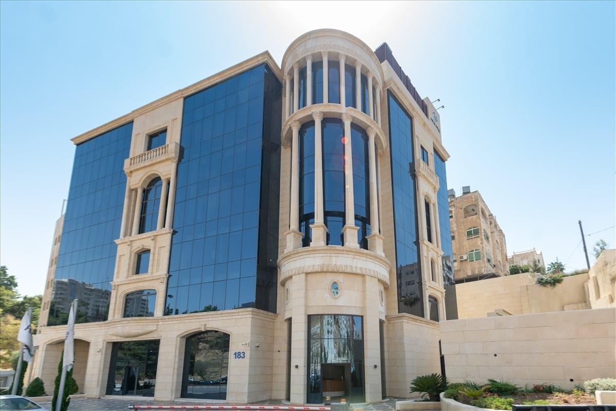 Exterior view of the modern stone and glass facade of the Armada Tower at 183 Saqra Complex A.