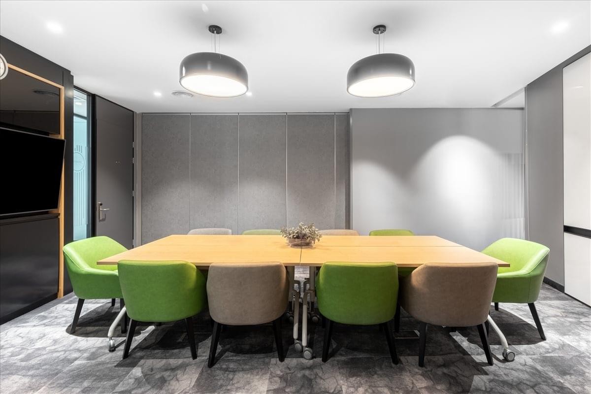 Modern meeting room at Residensi Tribeca (L6&7) featuring green and beige chairs.