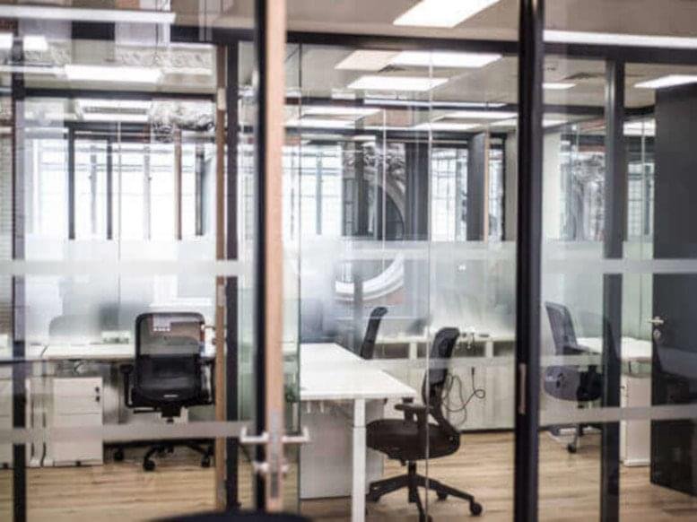 Modern glass-partitioned private offices at 1st Floor, Riyadh Front, King Khaled International Airport.