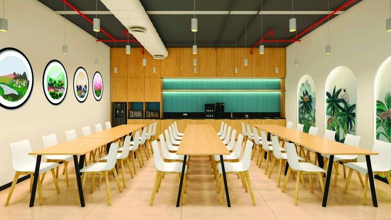 Spacious dining area at RMZ Centennial, C-Block, featuring long wooden tables and arched wall decor with greenery.