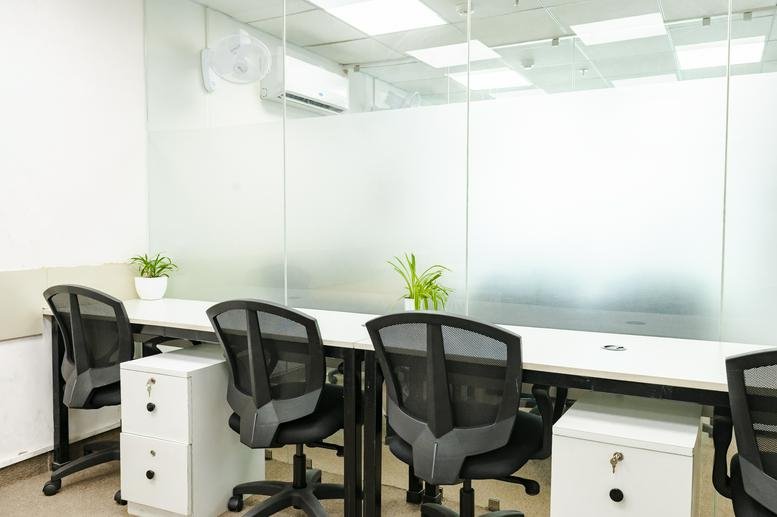 Workspace at Room no. -618, Floor, 6, Esplanade One Ln, Rasulgarh, Bhubaneswar with white desks and black mesh chairs.